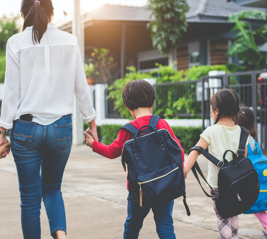 Mother and two children walking